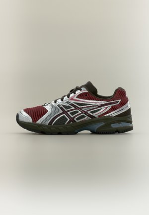 Running shoe featuring a mesh upper in red and silver, with dark brown accents, a cushioned sole, and reflective details for visibility.