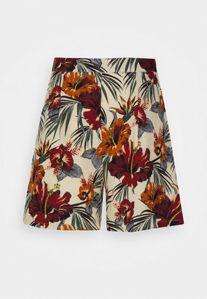Pantalones cortos de cintura alta con un estampado floral tropical en rojo, naranja, verde y gris sobre un fondo beige.