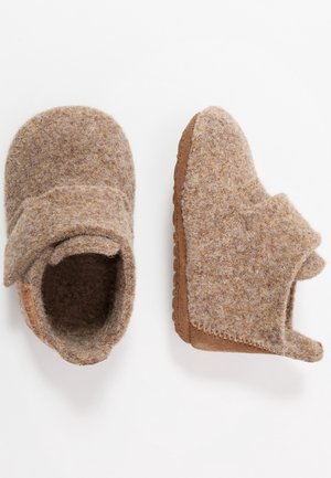 Pair of small beige woolen baby shoes with hook-and-loop straps and soft brown soles on a white background.