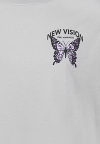 White cotton t-shirt featuring a black and purple graphic of a butterfly with the text "NEW VISION ONLY HAPPINESS" above it.