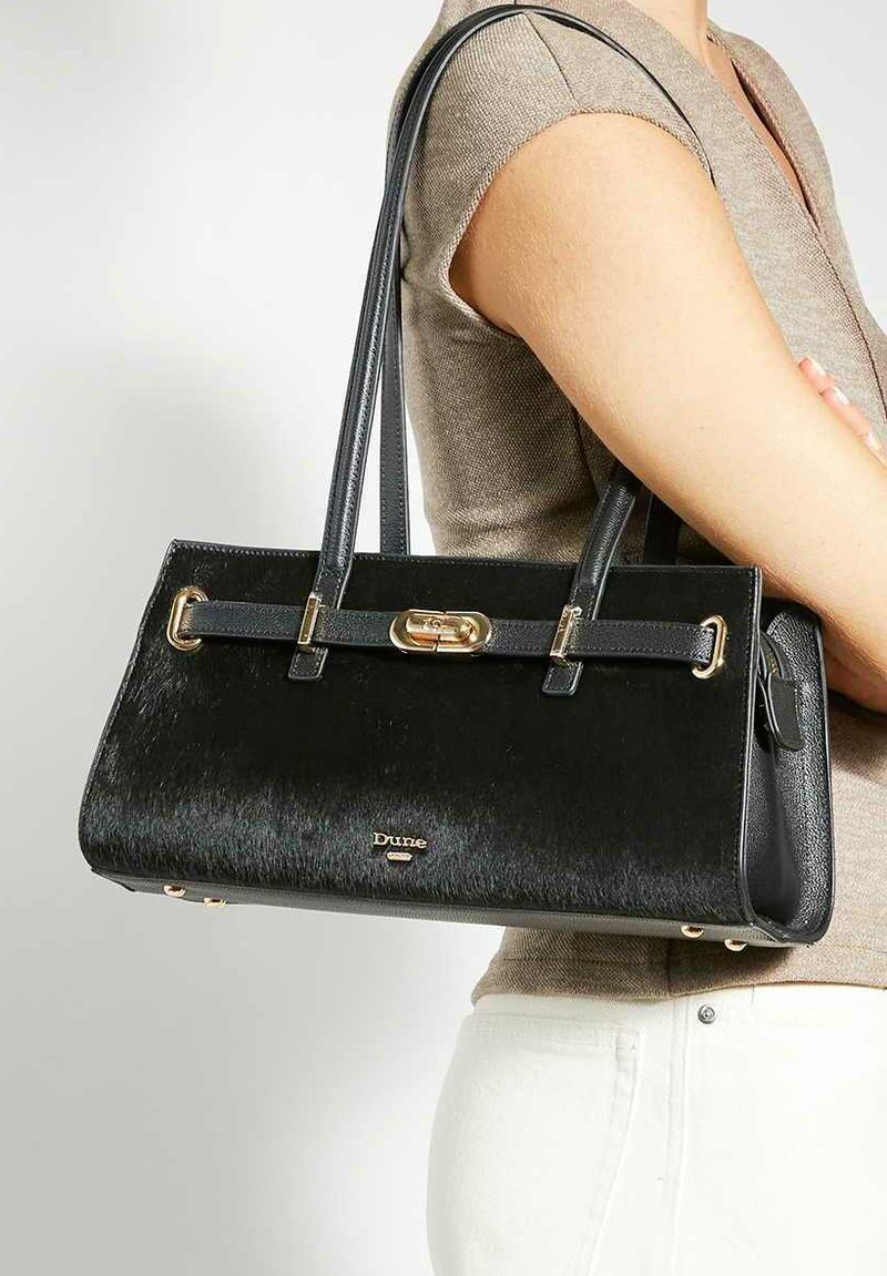 Black handbag with a mix of smooth and textured surfaces, featuring gold hardware, dual handles, and a sleek rectangular shape.