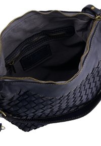 Woven dark blue leather handbag with a zippered top, interior pockets, and contrasting stitching. Soft texture and structured shape.