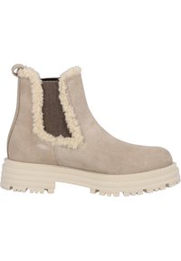 Beige suède enkellaarsjes met een fluffy kraag en bruine elastische zijpanelen. Dikke, witte rubberen zool met een gestructureerd loopvlak.