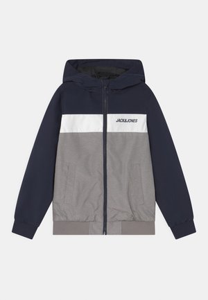 Color-blocked jacket with a navy upper section, white central stripe, and gray lower section. Features a zip closure and hooded design.