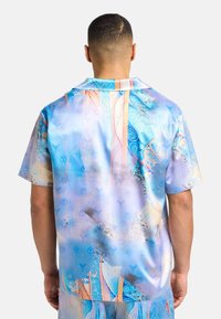 Short-sleeve shirt in lightweight, glossy fabric. Features a vivid blue and orange abstract pattern with swirls and geometric designs.