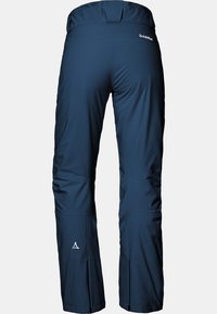 Navy blue outdoor pants with a smooth texture, featuring a high waistband, zippered side vents, and a small white logo on the back.