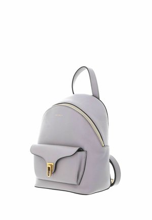 Light grey leather backpack with front pocket, gold clasp, curved top zipper, and single top handle.