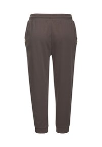 Dunkelbraune Jogginghosen aus weichem Stoff. Mit elastischem Bund, seitlichen Taschen mit Reißverschlüssen und gerippten Bündchen an den Knöcheln.