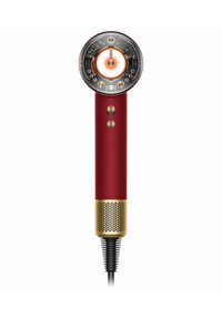 Roter Haartrockner mit rundem Kopf, goldenen Akzenten und schwarzem, strukturiertem Sockel. Verfügt über zwei Tasten am Griff und ein spiralförmiges Netzkabel.