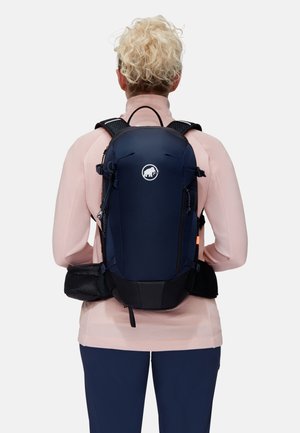 Navy blue hiking backpack with black accents, adjustable straps, and a front logo. Features durable fabric and a mesh back panel for ventilation.