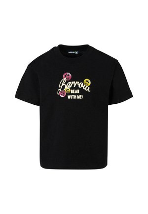 T-shirt en coton noir à manches courtes et col rond. Comprend des textes colorés et des graphiques de visages souriants en rose, jaune et noir.