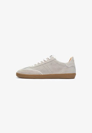 Zapatillas de hombre en ante gris claro con cordones blancos, diseño perforado y suela de goma marrón. Costuras en contraste y detalles de collar acolchado.