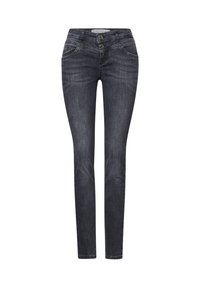 Mörk denim skinny jeans har en hög midja, två framfickor och dubbelknäppning. Subtila blekningar och sömnadsdetaljer är synliga.