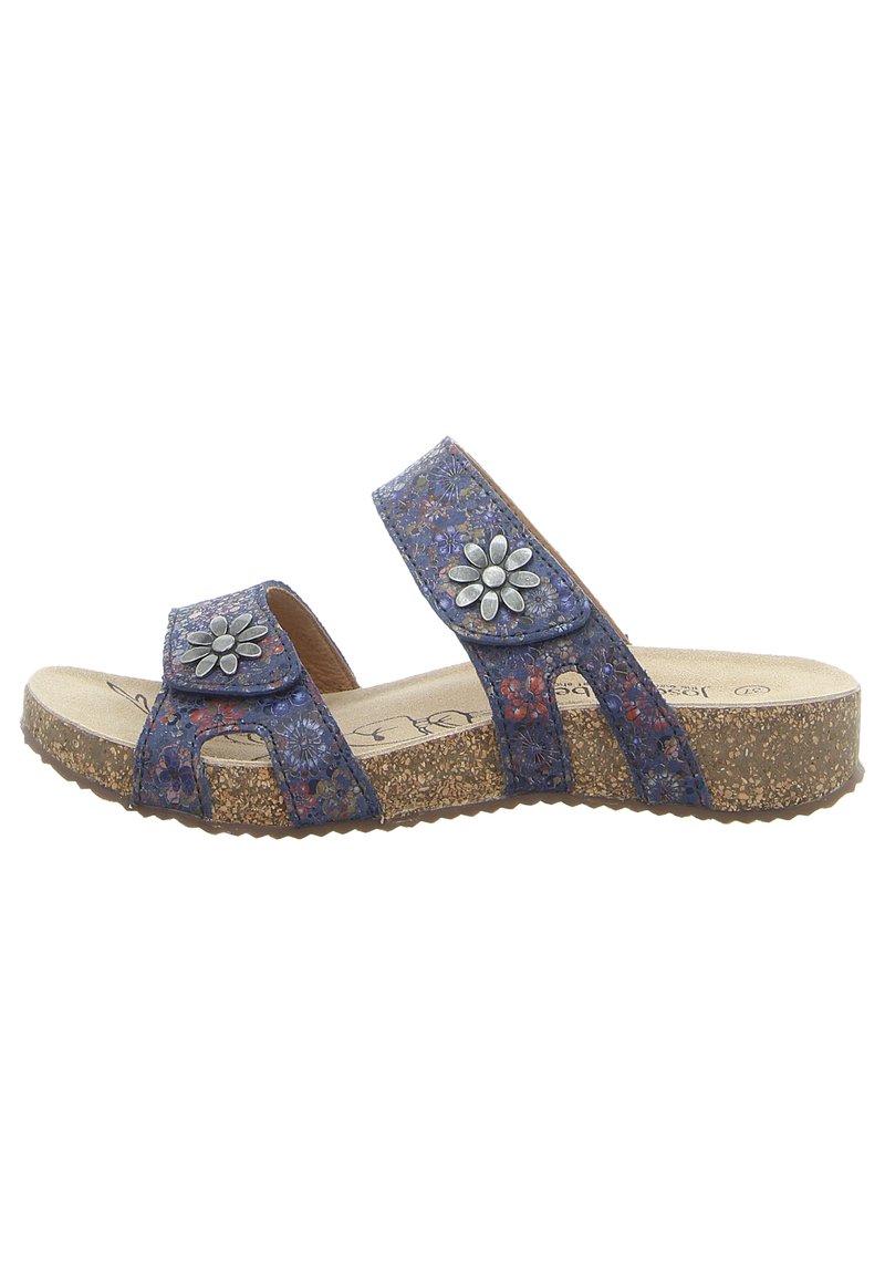 Floral-patterned blue slide sandals with two adjustable straps, silver floral accents, and a cork footbed. Lightweight and contoured design.