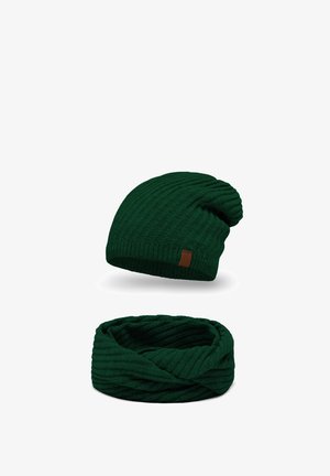 Dark green knit beanie with a slouchy design and textured pattern. Matching dark green infinity scarf with a similar ribbed texture.