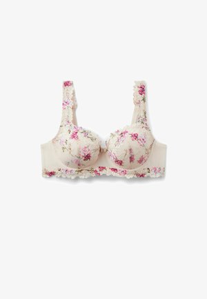 Soutien-gorge en dentelle couleur crème avec broderie florale rose et violette, bords ondulés et larges bretelles sur fond blanc.