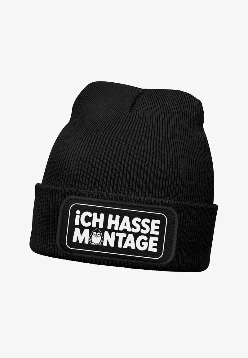 Black knitted beanie with a cuff and a rectangular patch featuring the text “¡ICH HASSE MONTAGE!” in white and a cartoon penguin graphic.
