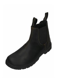 Botín Chelsea de cuero negro con paneles laterales elásticos, costuras reforzadas y suela de goma texturizada. Cuenta con tiradores para facilitar el calzado.