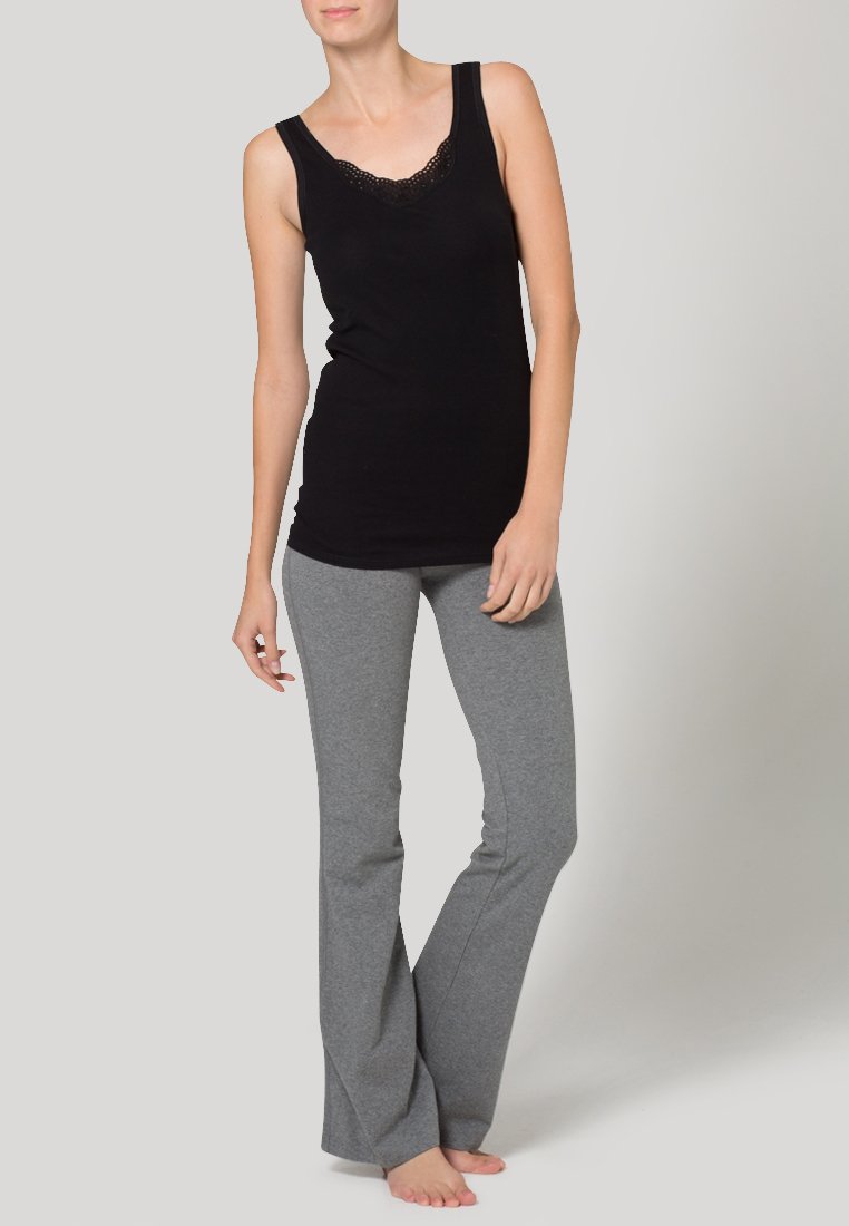 Black tank top with lace trim and gray flared sweatpants, made from soft, stretchy fabric, featuring a fitted silhouette and casual design.