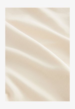 Smooth, off-white fabric with subtle folds and a soft texture, captured in close-up view.