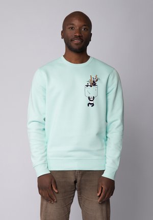 Mintgrüner Sweatshirt mit einem Pandadesign auf der Tasche, verziert mit Stäbchen und Bambusillustrationen. Weicher Stoff, Rundhalsausschnitt, gerippte Bündchen.