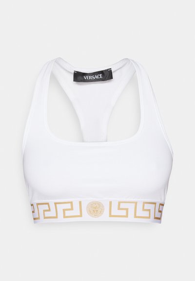 Baltas sportinis liemenukas su auksiniu Graikijos raktų raštu ir Versace logotipu apatine dalyje. Turi lenktą nugarą ir tamprių medžiagą.