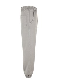 Lys grå svedbukser med en elastisk talje, sidelommer og elastiske manchetter ved anklerne. Fremstillet af blødt, åndbart stof.