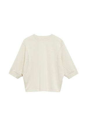 Felpa oversize color crema con maniche corte, scollo tondo e polsini a coste, mostrata distesa su uno sfondo bianco.