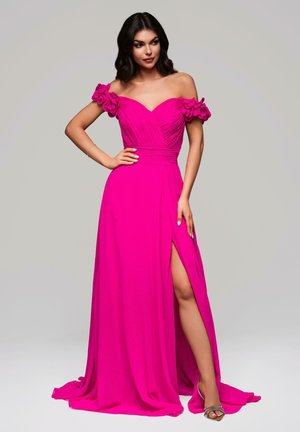 Fuchsia off-shoulder gown with floral accents, pleated bodice, and side slit. Flows elegantly to the floor with a smooth finish.