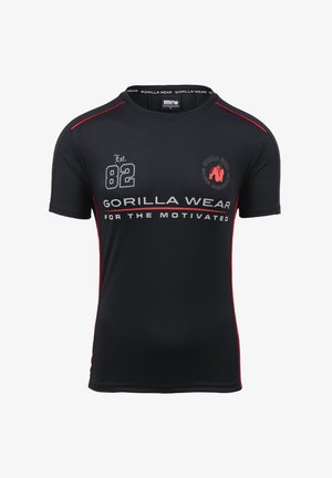 Zwarte sport T-shirt met rode accenten, voorzien van de tekst "Gorilla Wear" en "FOR THE MOTIVATED," en een logo op de borst. Korte mouwen.
