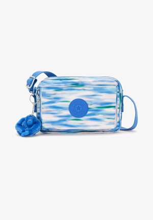 Blue patterned crossbody bag featuring a smooth texture, adjustable strap, and a plush monkey keychain. Logo embossed on the front.
