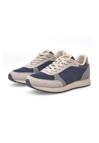 Navy and beige sneakers featuring a mesh upper, suede accents, and a textured sole. Laces and padded collar for comfort.