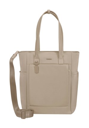Beige tote bag with two handles, a front pocket, side pockets, and an adjustable shoulder strap placed on a white background.