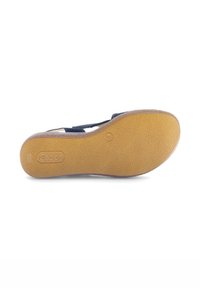 Sandaalzool van gestructureerd bruin rubber met een gebogen vorm. Voorzien van een logo dat op de hiel is geperst en een schoon, eenvoudig ontwerp.