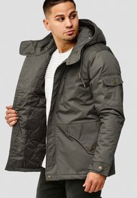 Men's dark gray insulated jacket with a hood, featuring front pockets, zipper closure, and snap buttons, displayed partially open.