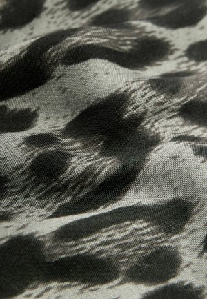Tissu noir et gris présentant un motif abstrait et ondulé. La texture semble lisse avec un léger éclat.