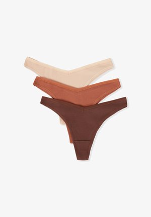 Three pairs of ribbed thongs in beige, rust, and dark brown. Each features a soft, elastic waistband and a low-cut design.