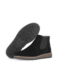 Zwarte suède enkellaarsjes met elastische zijpanelen, een gestructureerde rubberen zool, contrasterende lichtbruine rand en een robuust profiel voor grip.