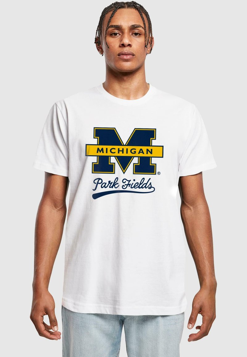 White cotton t-shirt featuring a large blue "M" with yellow accents and the text "Michigan Park Fields" in blue cursive below.