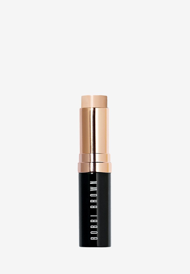 Lippenstiftbehälter mit schwarzem mattem Boden und glänzendem roségoldenem Deckel. Auf der Seite ist der Markenname "BOBBI BROWN" in Weiß zu sehen.