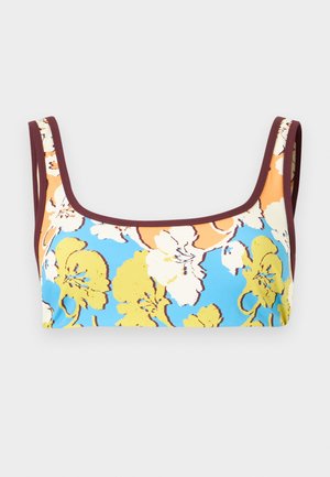 Crop top so širokými ramienkami, s jasným kvetinovým vzorom v žltej, bielej a oranžovej farbe na modrom podklade s tmavohnedým lemom.