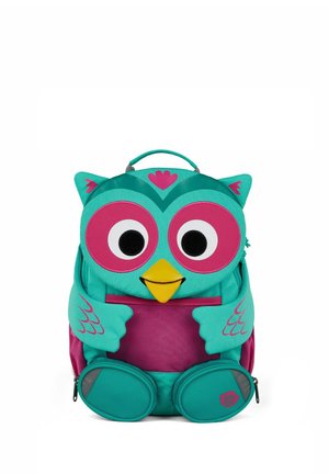 Turquoise and pink owl-shaped children's backpack with large eyes, yellow beak, wing and paw details, and a top carry handle.