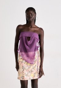 Purple strapless top with a keyhole cutout and ruffled edges; paired with a floral sequined skirt in pastel colors and subtle metallic accents.