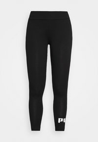 Black leggings made from a stretchy fabric with a smooth texture. Features a wide waistband and a white logo printed near the ankle.
