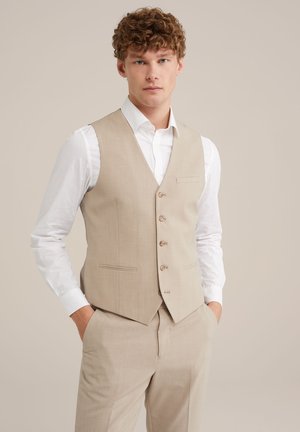 Beige fabric vest with five buttons, single chest pocket, and two front pockets. Worn over a white shirt, featuring a tailored fit and smooth texture.