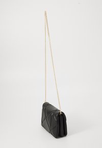 Black quilted leather crossbody bag with gold-tone chain strap, rectangular shape, and flap closure on white background.