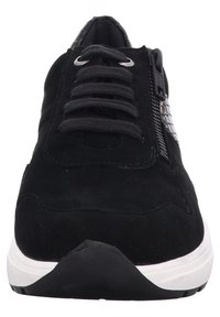 Black sneaker with a smooth suede upper, featuring a textured side panel, flat laces, and a white rubber sole. Zipper detail on the side.