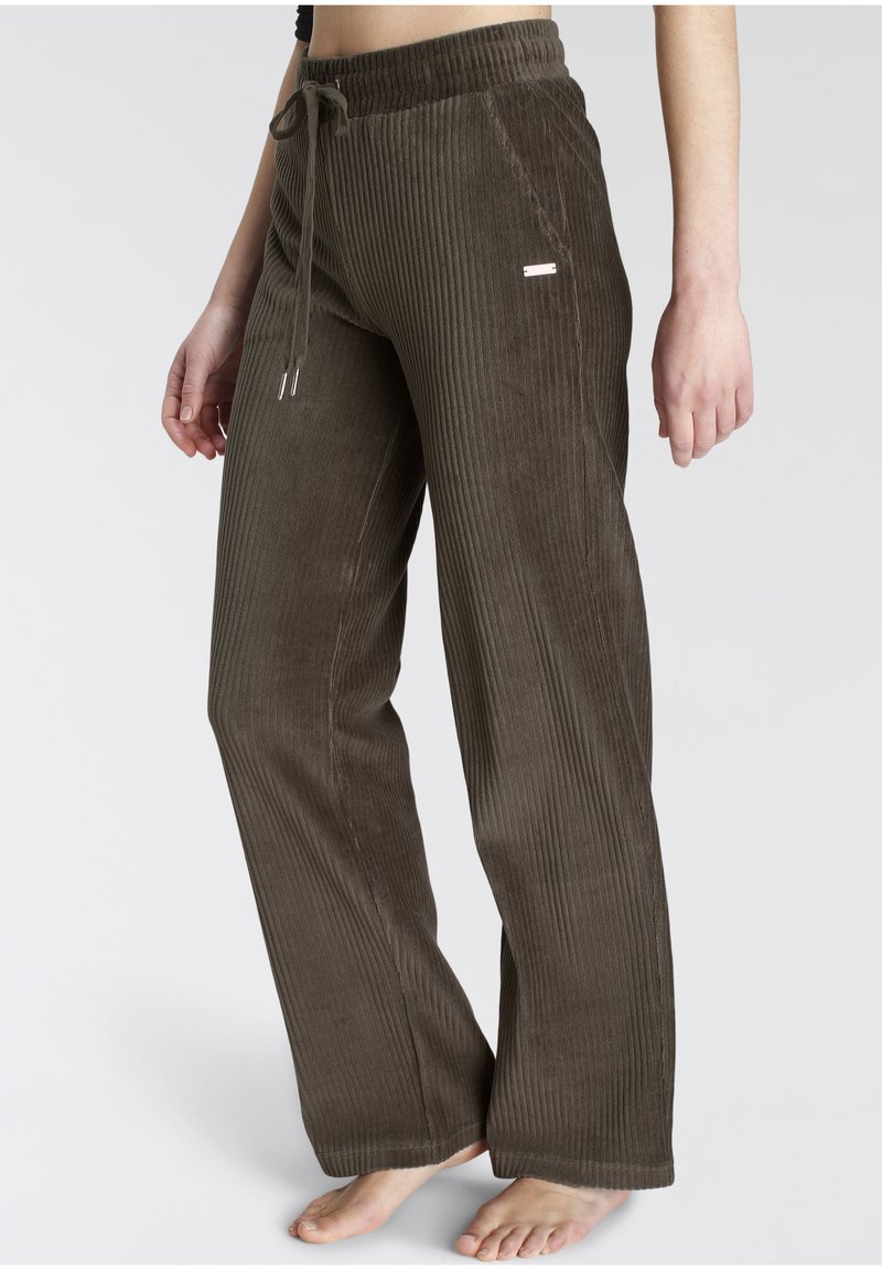 Brown corduroy pants with a ribbed texture, elastic waistband, adjustable drawstring, and a small metallic accent on the side.