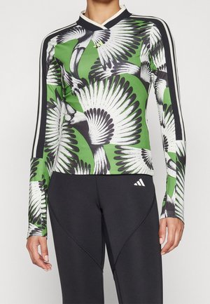 Langarm sporttop met een groen en zwart vogelgraphicpatroon, gemaakt van rekbare stof. Heeft een contrasterende kraag en zijstrepen.