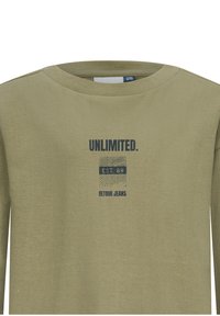 Zielona oliwkowa koszula z długim rękawem i okrągłym dekoltem. Z przodu znajduje się niebieski napis "UNLIMITED." oraz graficzna etykieta z napisem "EST. 89 RETOUR JEANS."